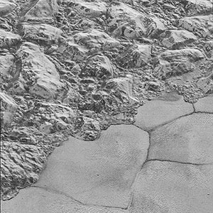 Mountains of ice along a portion of smoother ice planes on Pluto’s surface